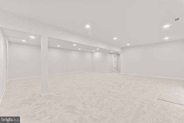 basement featuring light carpet