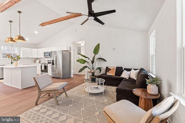 living room with ceiling fan, high vaulted ceiling, and hardwood / wood-style floors