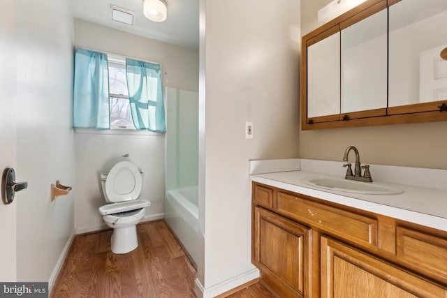 bathroom featuring hardwood / wood-style flooring, vanity, and toilet