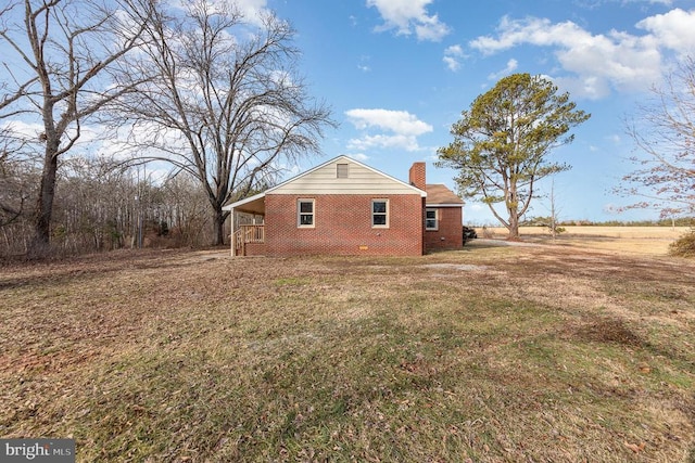 view of side of property with a lawn