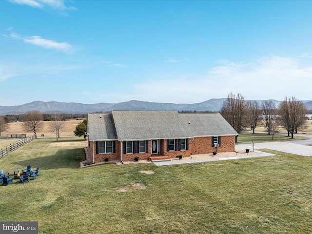 view of front of property with a mountain view and a front lawn