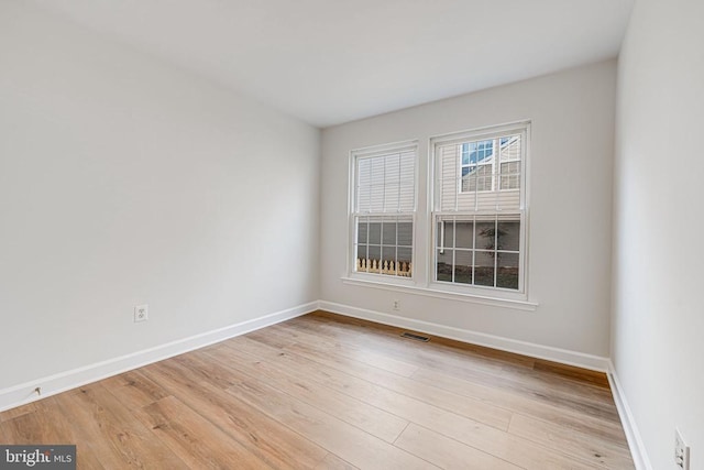 spare room with light wood-type flooring