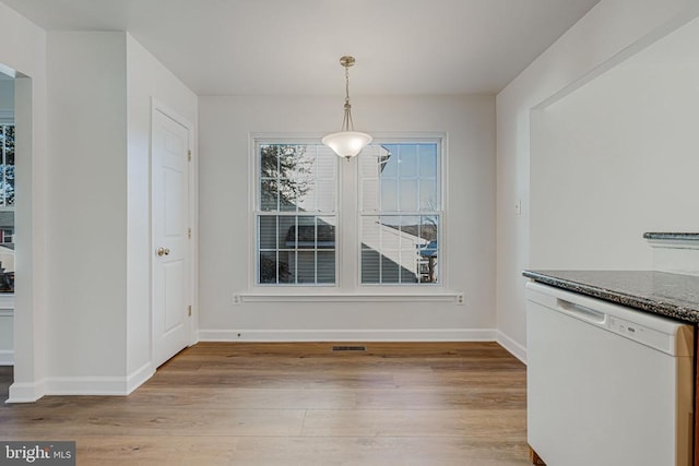 unfurnished dining area with light hardwood / wood-style floors