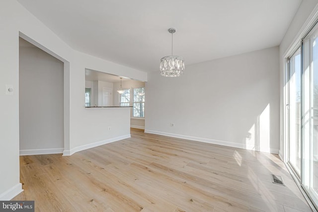 interior space featuring a notable chandelier and light hardwood / wood-style flooring