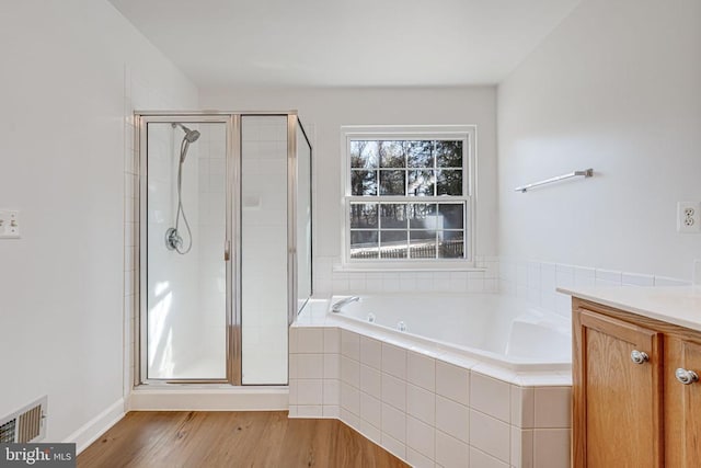 bathroom with vanity, hardwood / wood-style flooring, and independent shower and bath