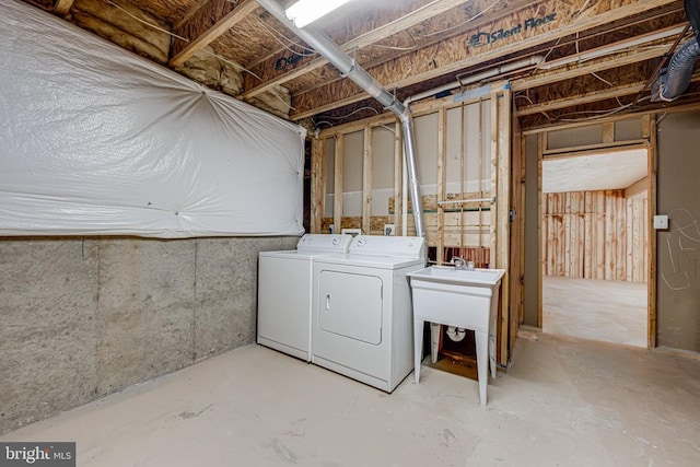 basement featuring sink and washer and dryer