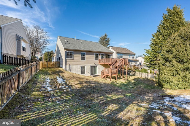 rear view of property featuring a deck