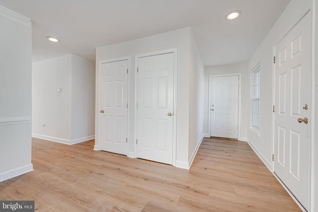 corridor with light hardwood / wood-style flooring