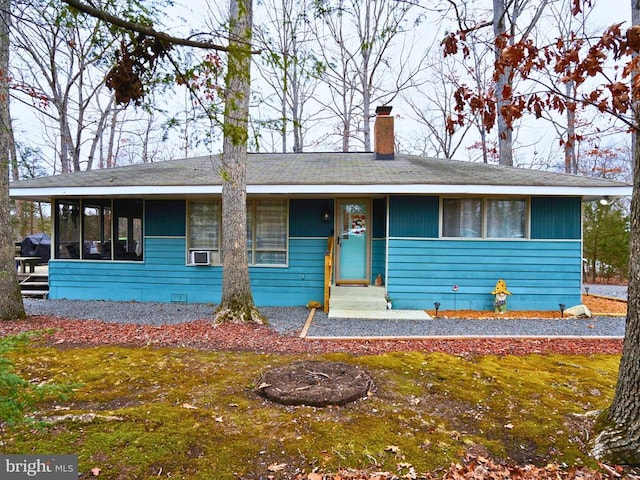 single story home with a sunroom and a front lawn