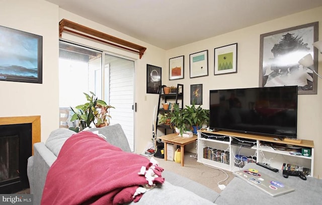 living room featuring carpet and a fireplace