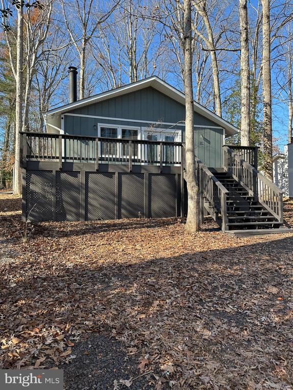 view of property exterior featuring a wooden deck