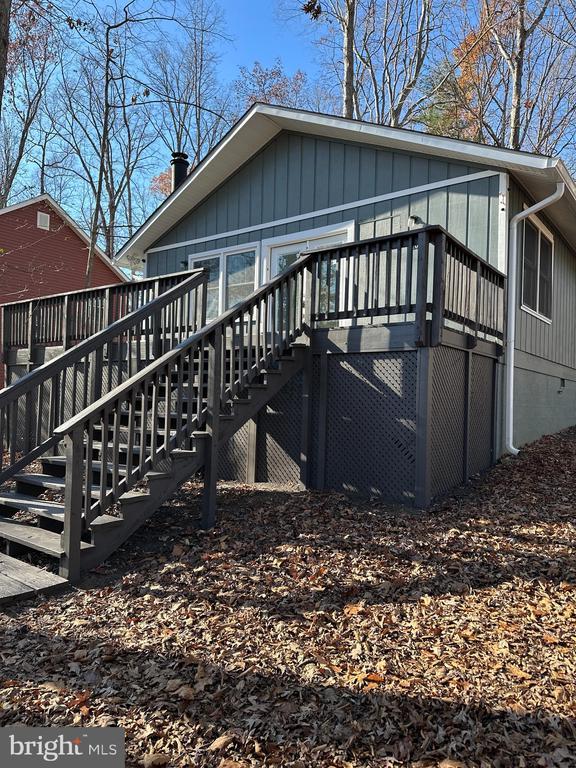 back of house with a wooden deck