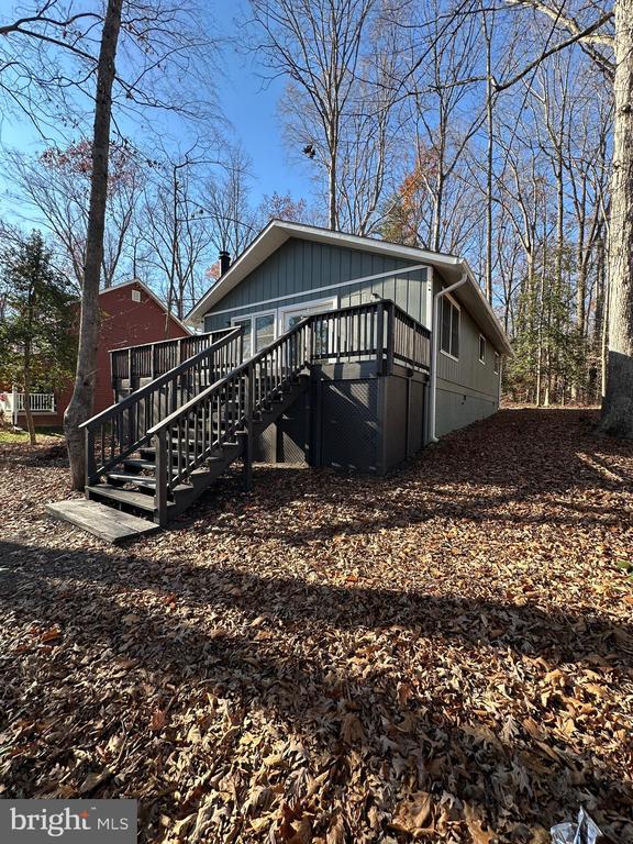 view of home's exterior featuring a wooden deck