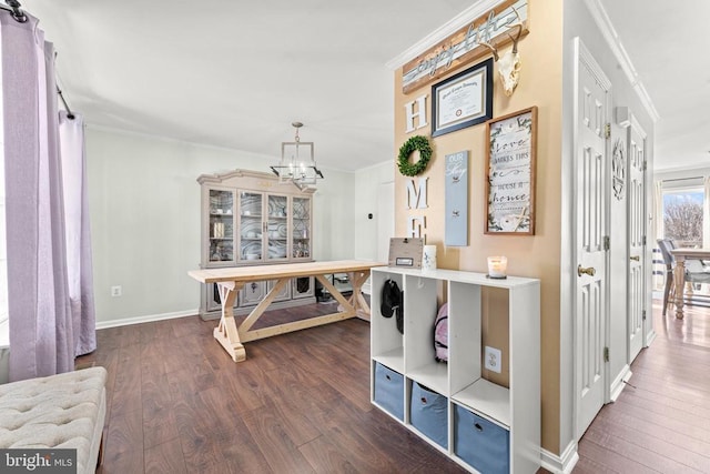 interior space with crown molding, dark hardwood / wood-style floors, and a chandelier