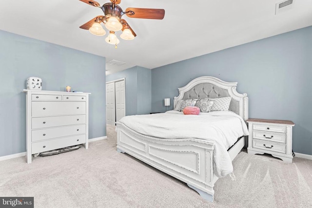 carpeted bedroom with ceiling fan and a closet