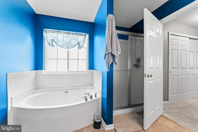 bathroom with tile patterned floors and independent shower and bath