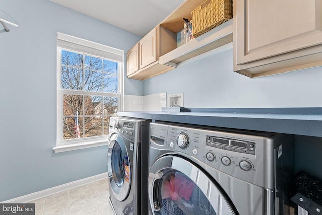 laundry area with cabinets and washing machine and clothes dryer