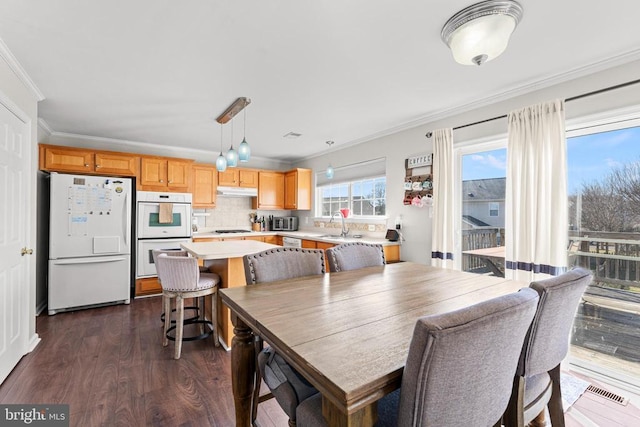 dining room featuring crown molding and dark hardwood / wood-style flooring