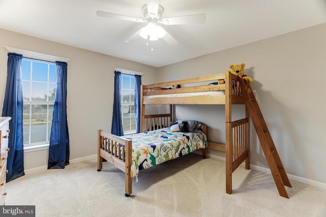 carpeted bedroom featuring ceiling fan and baseboards