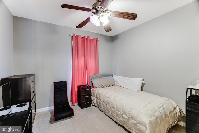 carpeted bedroom featuring baseboards and a ceiling fan