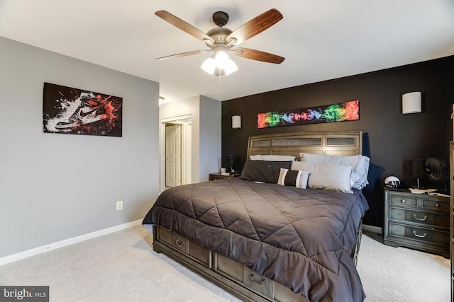 bedroom with light colored carpet, ceiling fan, and baseboards