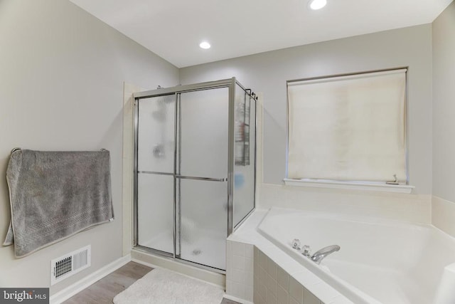 bathroom featuring a garden tub, recessed lighting, visible vents, a stall shower, and wood finished floors