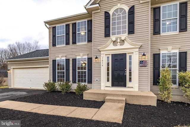 view of front of property with driveway and an attached garage