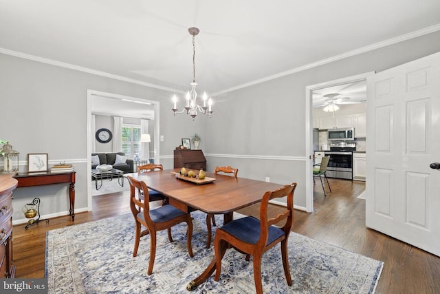 dining room with an inviting chandelier, crown molding, dark wood-style floors, and baseboards