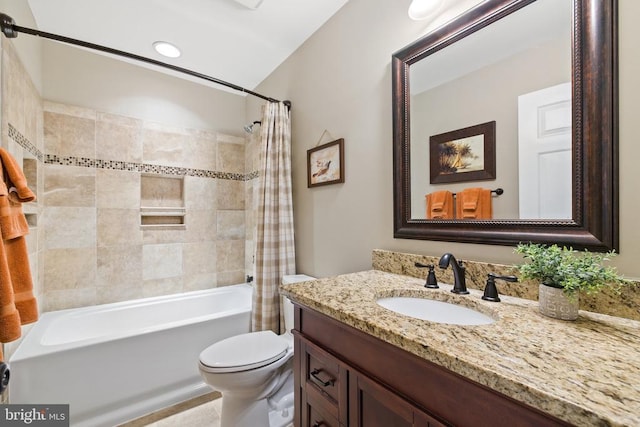 bathroom with shower / tub combo with curtain, toilet, and vanity