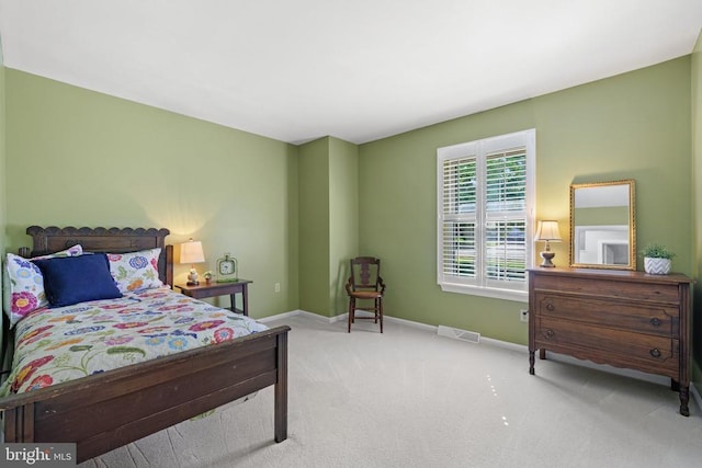 bedroom featuring visible vents, baseboards, and carpet