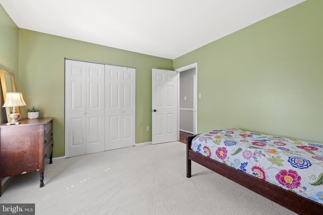 bedroom featuring carpet, a closet, and baseboards