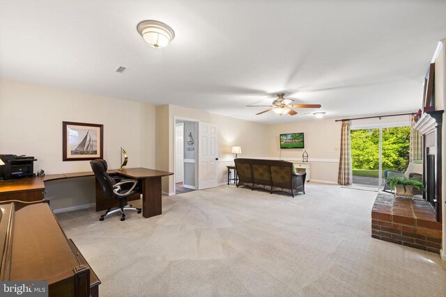 office with visible vents, baseboards, light colored carpet, and a ceiling fan