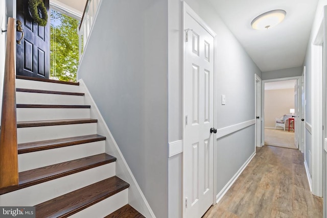 stairway featuring wood finished floors and baseboards