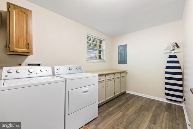 clothes washing area featuring baseboards, dark wood finished floors, electric panel, cabinet space, and separate washer and dryer