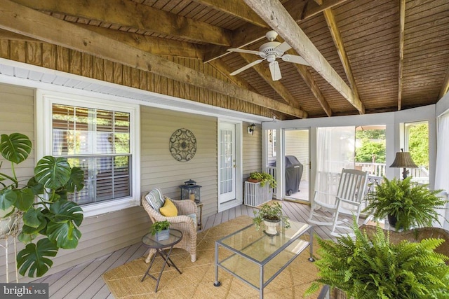 unfurnished sunroom with lofted ceiling with beams, wood ceiling, and ceiling fan