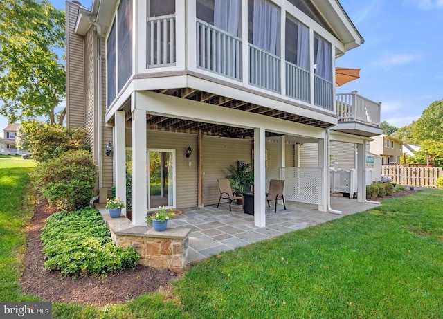 back of house featuring a lawn, a patio, and fence