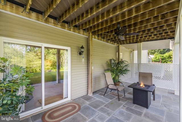 view of patio / terrace with ceiling fan and an outdoor fire pit