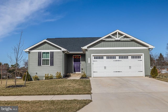 view of front of property with board and batten siding, a shingled roof, a front lawn, concrete driveway, and a garage