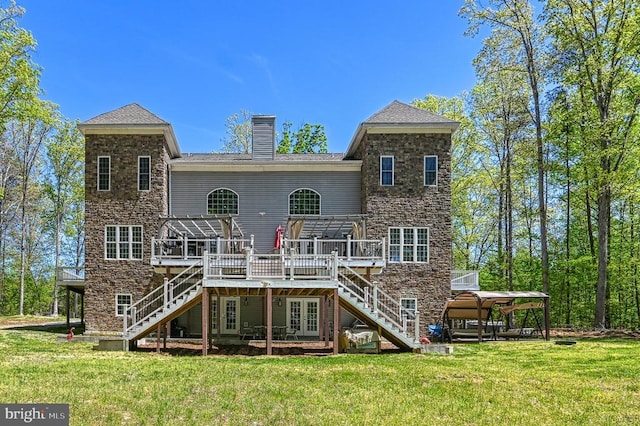 back of house with a yard, a chimney, a wooden deck, and stairs