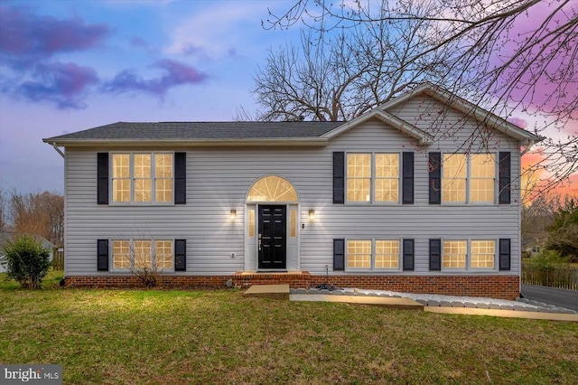 bi-level home with a front lawn