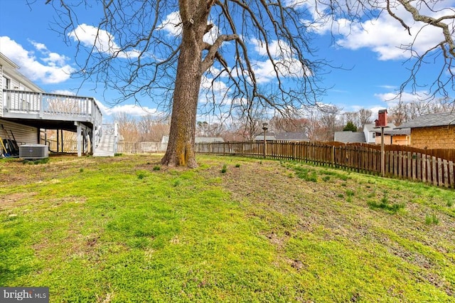 view of yard featuring stairway, central AC, a wooden deck, and fence