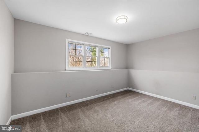 unfurnished room with visible vents, baseboards, and carpet