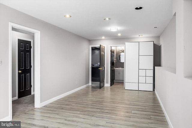 interior space featuring recessed lighting, light wood-style flooring, and baseboards