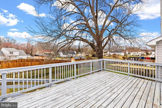 wooden terrace with a residential view and fence