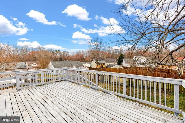 wooden deck featuring a residential view and fence