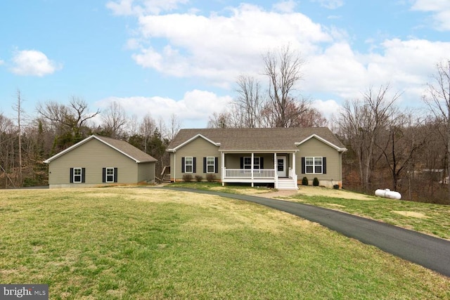 ranch-style home with a porch and a front lawn