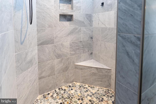 bathroom with tiled shower