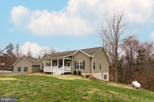 view of front of property with covered porch and a front yard