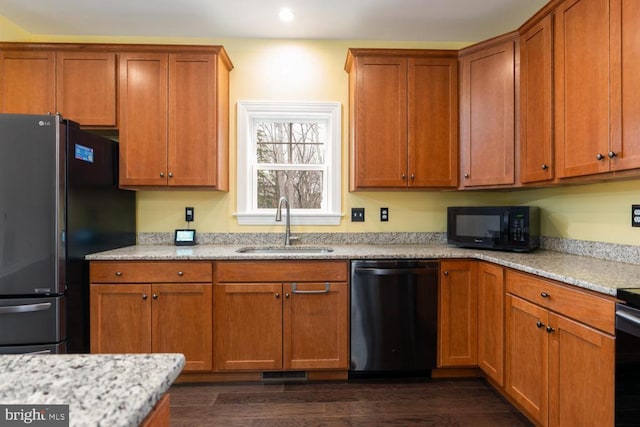 kitchen with dishwashing machine, dark wood-style floors, freestanding refrigerator, a sink, and black microwave