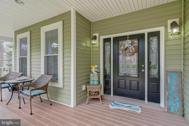 view of exterior entry featuring a porch